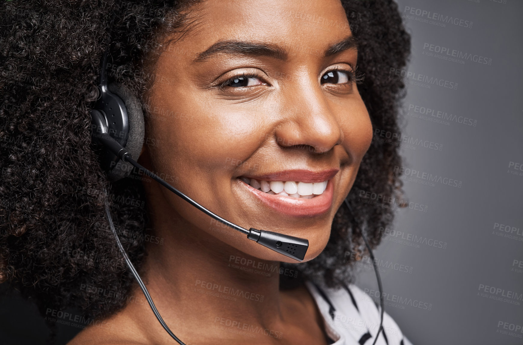 Buy stock photo Studio portrait of a confident young phone operator posing against a gray background