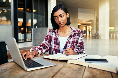 Buy stock photo Cropped shot of a young female student studying outside on campus