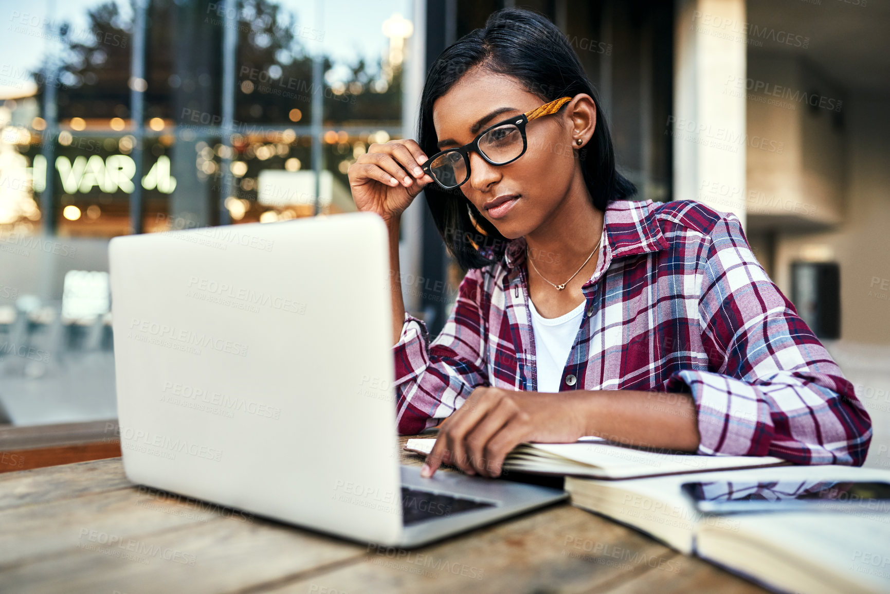 Buy stock photo Girl, laptop and books at university, outdoor and study for exam, writing and notes for development. Person, computer and reading for research, glasses or learning with info for education at college