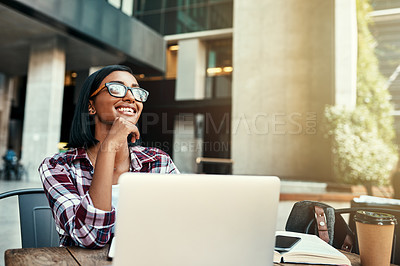 Buy stock photo Cropped shot of a young female student using a laptop outside on campus