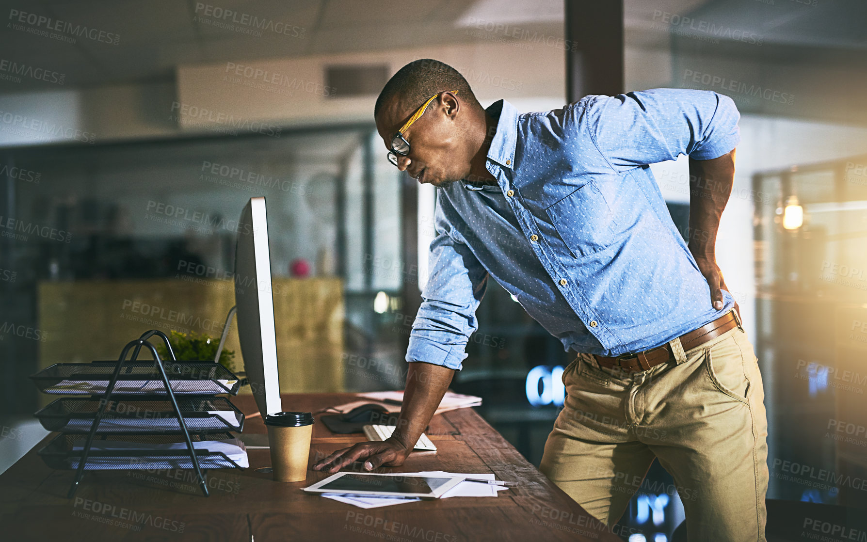 Buy stock photo Black man with back pain, night business and stress with injury, health problem and burnout from overtime. Male professional work late, backache and medical emergency with bad posture and overworked