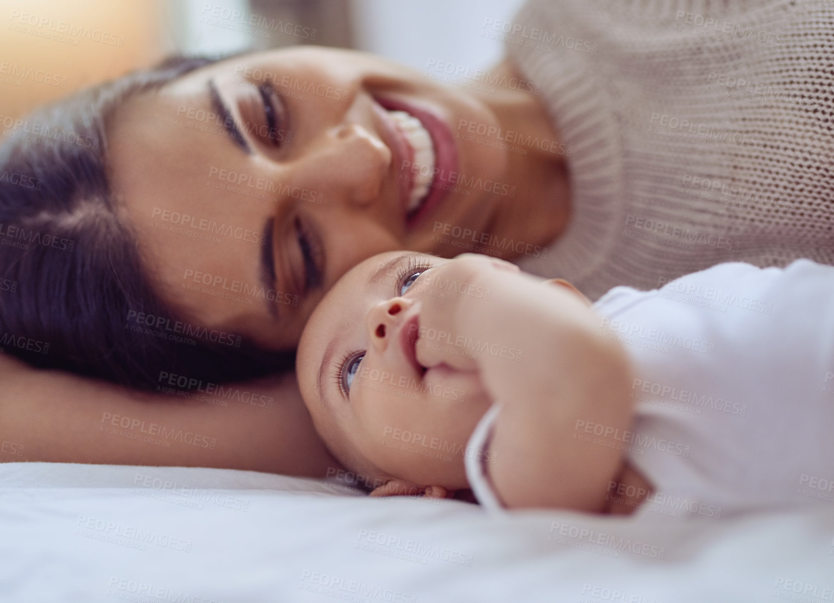 Buy stock photo Shot of a young woman bonding with her baby boy at home