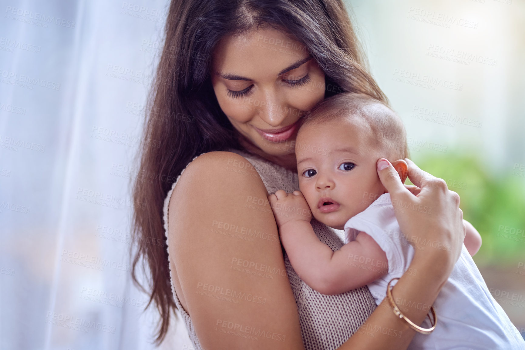 Buy stock photo Shot of a young woman bonding with her baby boy at home