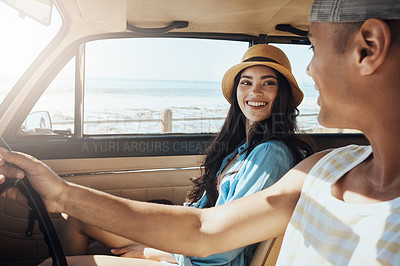 Buy stock photo Shot of a young couple enjoying a road trip along the coast