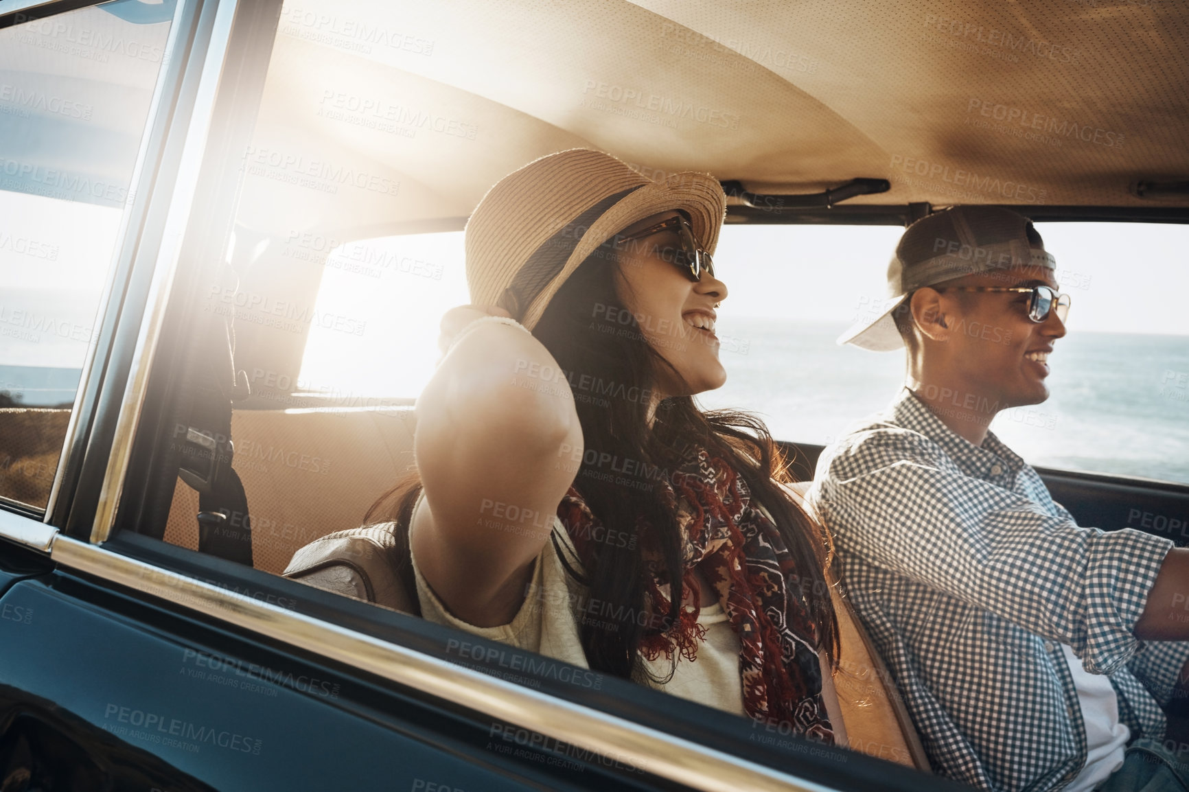 Buy stock photo Couple, sea and driving in car for road trip with smile, sunshine or sunglasses on vacation. Man, woman and interracial love for travel, transport or connection by ocean for happy memory in Australia