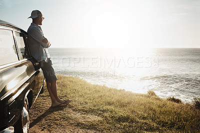 Buy stock photo Shot of a young man on a road trip along the coast