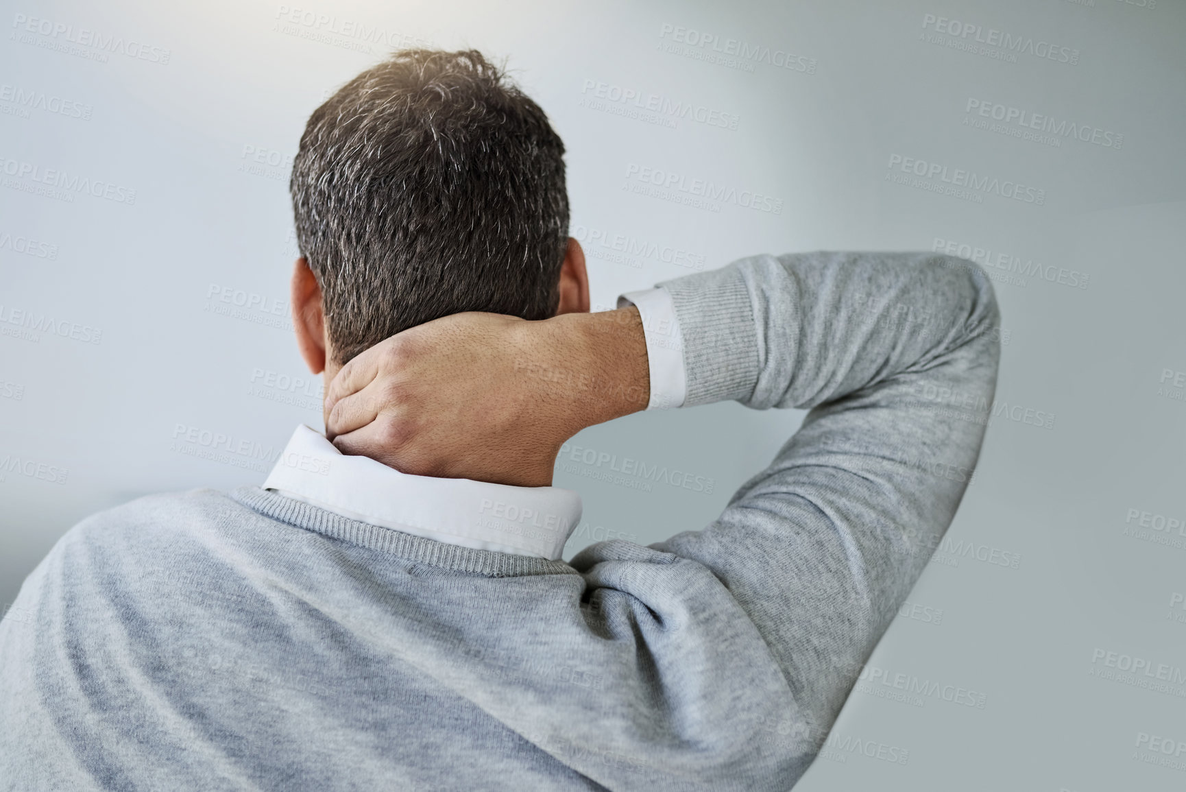 Buy stock photo Rearview shot of a businessman holding his neck in pain