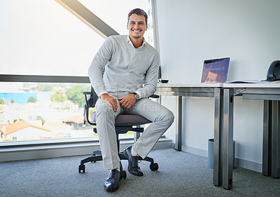 Buy stock photo Portrait of a handsome young businessman working in an office