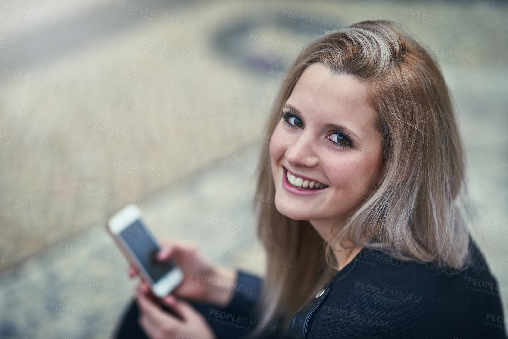 Buy stock photo Shot of an attractive woman using a mobile phone in the city