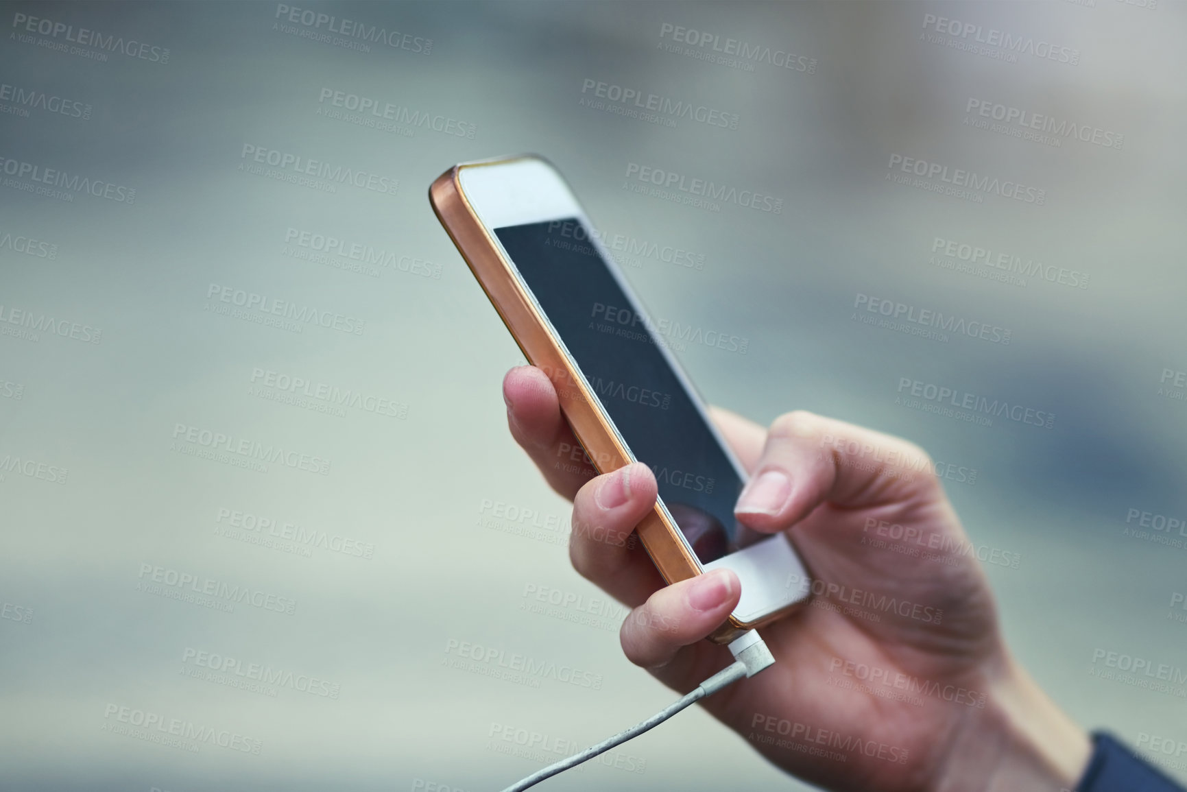 Buy stock photo Cropped shot of a woman using a mobile phone outdoors