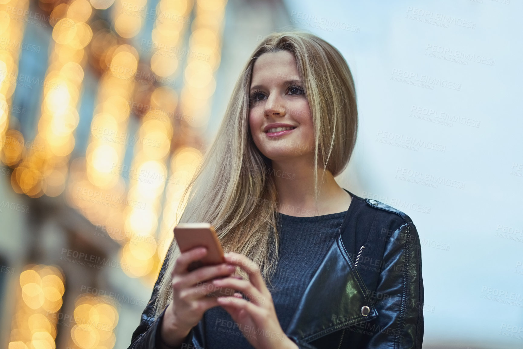 Buy stock photo Shot of an attractive woman using a mobile phone in the city