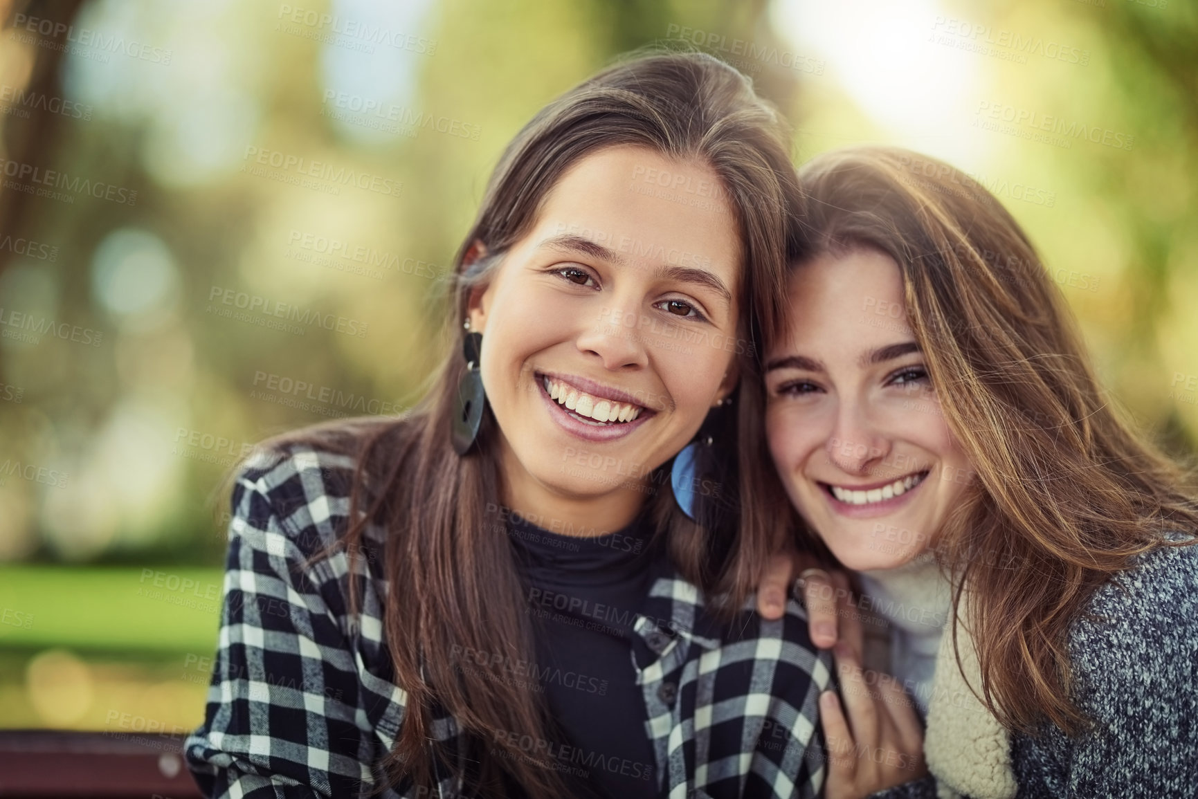 Buy stock photo Cropped portrait of two attractive young women spending the day outdoors