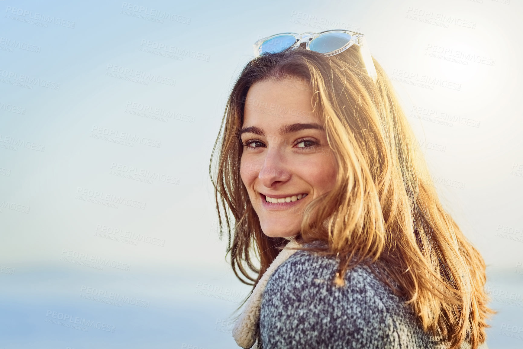 Buy stock photo Cropped portrait of an attractive young woman spending a day by the ocean
