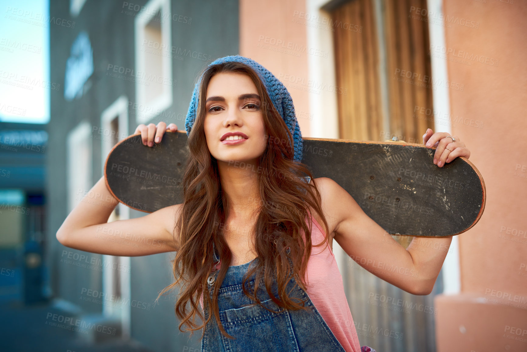 Buy stock photo Girl, skateboard and portrait in city, road and walk with fashion, travel and happy with action sport. Woman, person and skater with transport, youth culture and streetwear on sidewalk in Germany