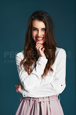 Buy stock photo Studio shot of an attractive young fashionable woman posing against a blue background