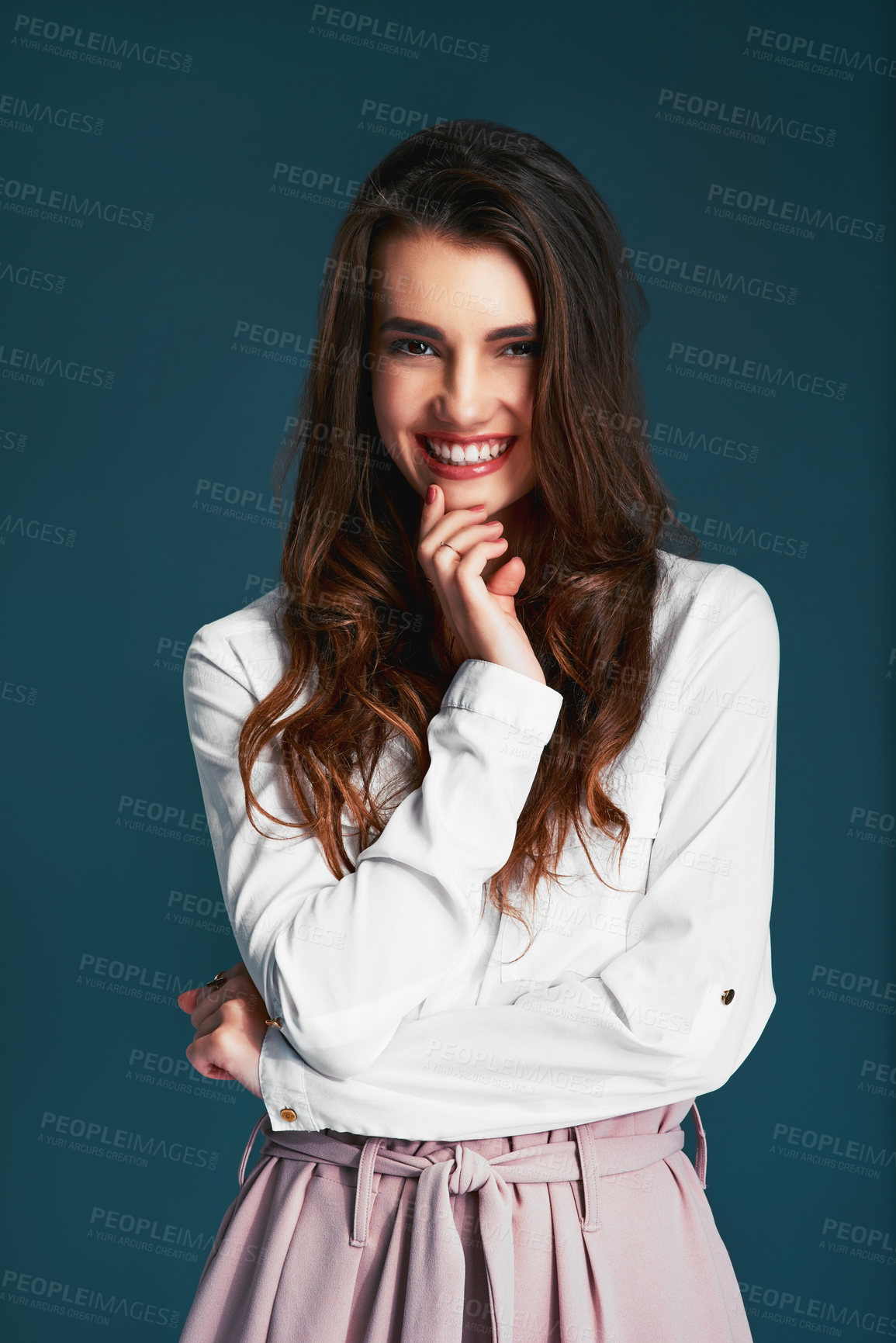 Buy stock photo Studio shot of an attractive young fashionable woman posing against a blue background