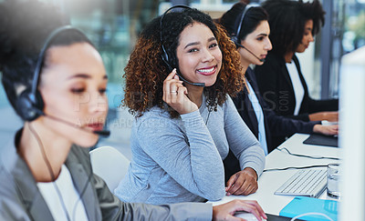 Buy stock photo Portrait of a young woman working in a call centre alongside her colleagues