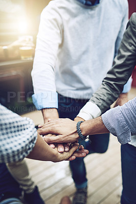 Buy stock photo Shot of a group of unrecognizable work colleagues forming a huddle with their hands outside during the day