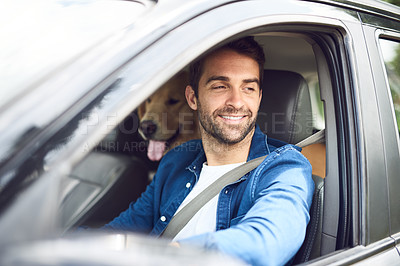 Buy stock photo Cropped shot of a handsome young man taking a drive with his dog in the backseat