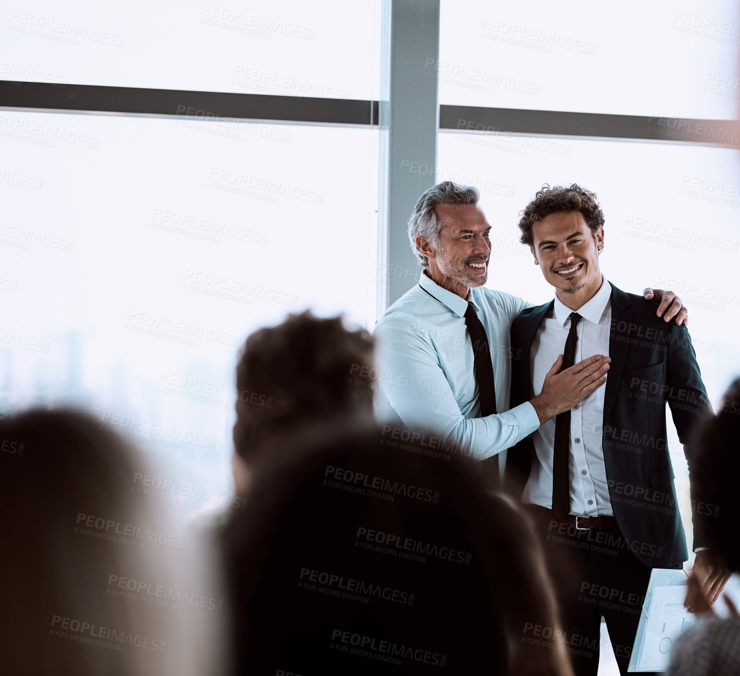 Buy stock photo Shot of a mature businessman introducing a colleague during a conference