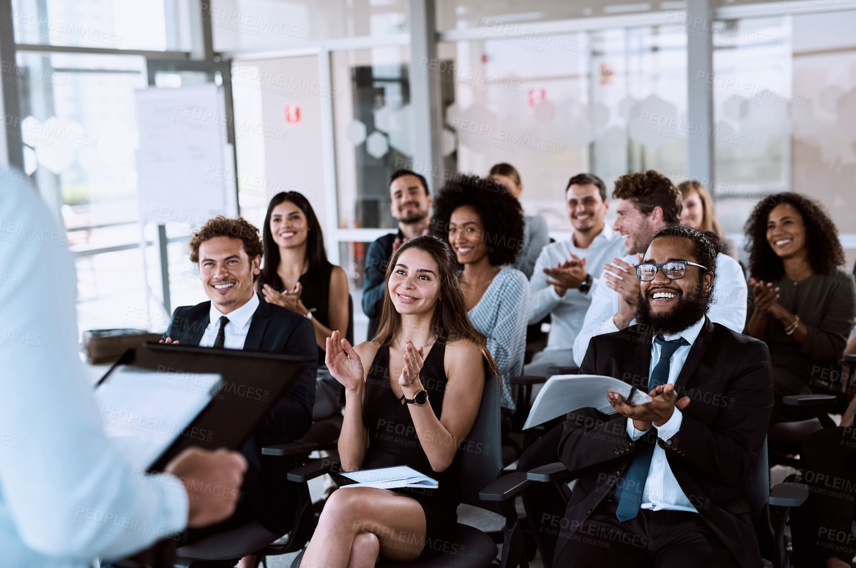 Buy stock photo Shot of a group of businesspeople clapping during a conference