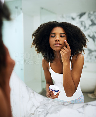 Buy stock photo Skin care, bathroom mirror and black woman with lotion, cosmetic product and morning grooming. Health, wellness and dermatology, skincare at home and girl in reflection with cream on face for beauty.