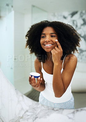 Buy stock photo Skin care, happiness and black woman in bathroom mirror with cream, smile and morning dermatology routine. Health, wellness and luxury skincare at home, girl in reflection and lotion on face for glow