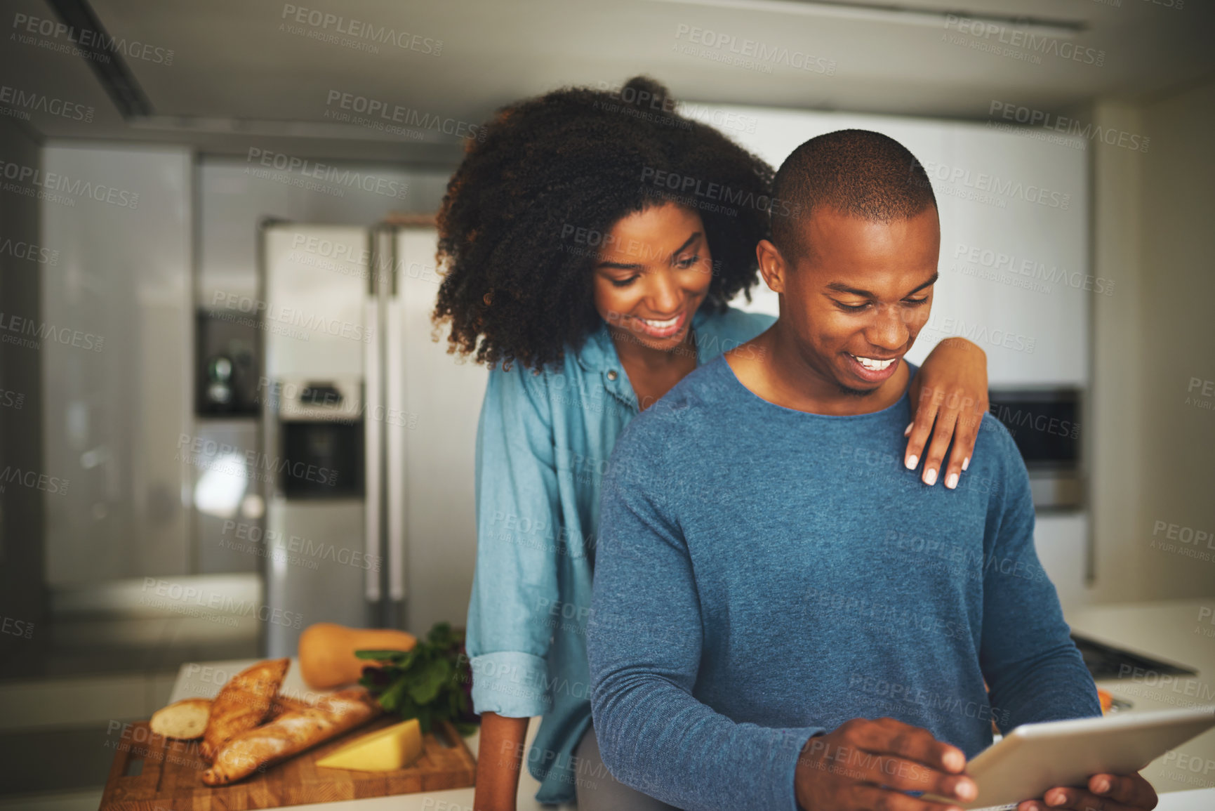 Buy stock photo Black couple, smile and tablet in kitchen with love, hug and reading website for dinner recipe. Man, woman and tech at home for social media, viral food hack and support in relationship for bonding