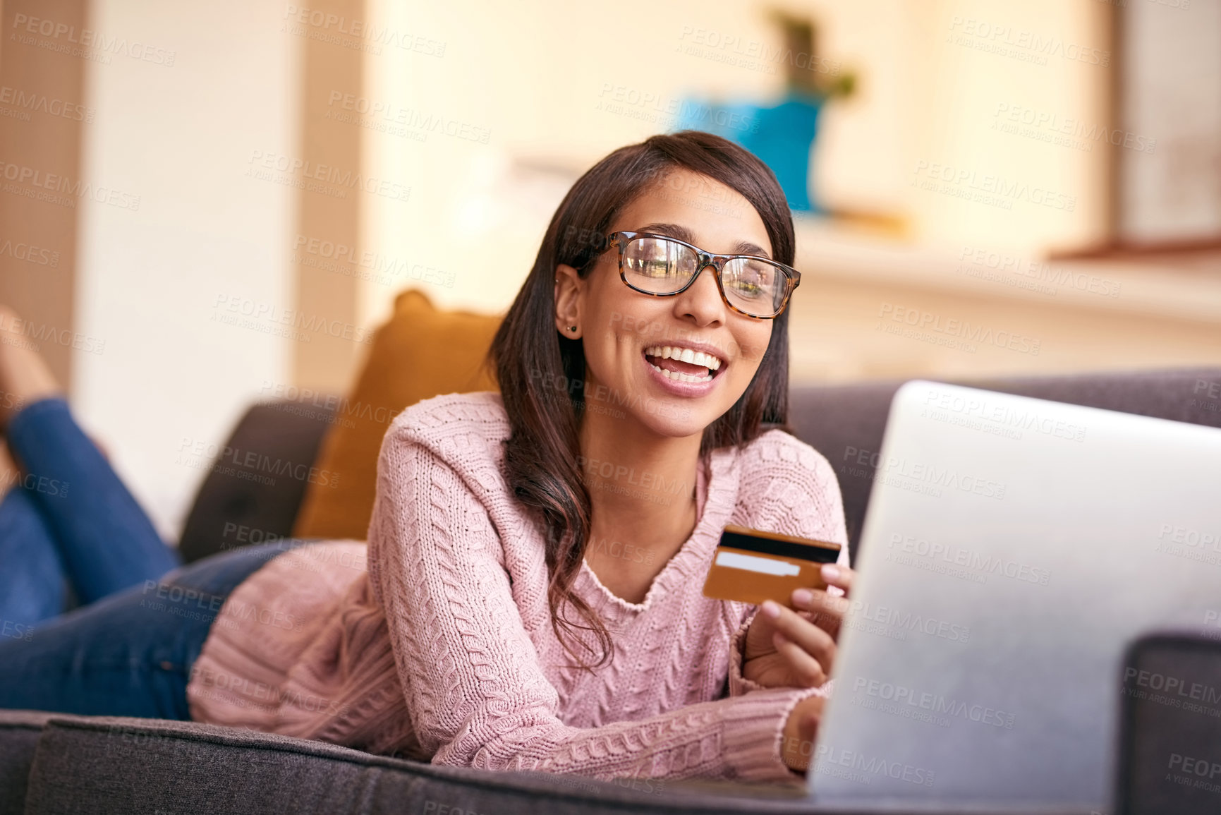 Buy stock photo Credit card, laptop and woman on sofa in home with happiness for paying bills with debt free lifestyle. Smile, computer and female person with internet banking app to apply for mortgage in apartment.