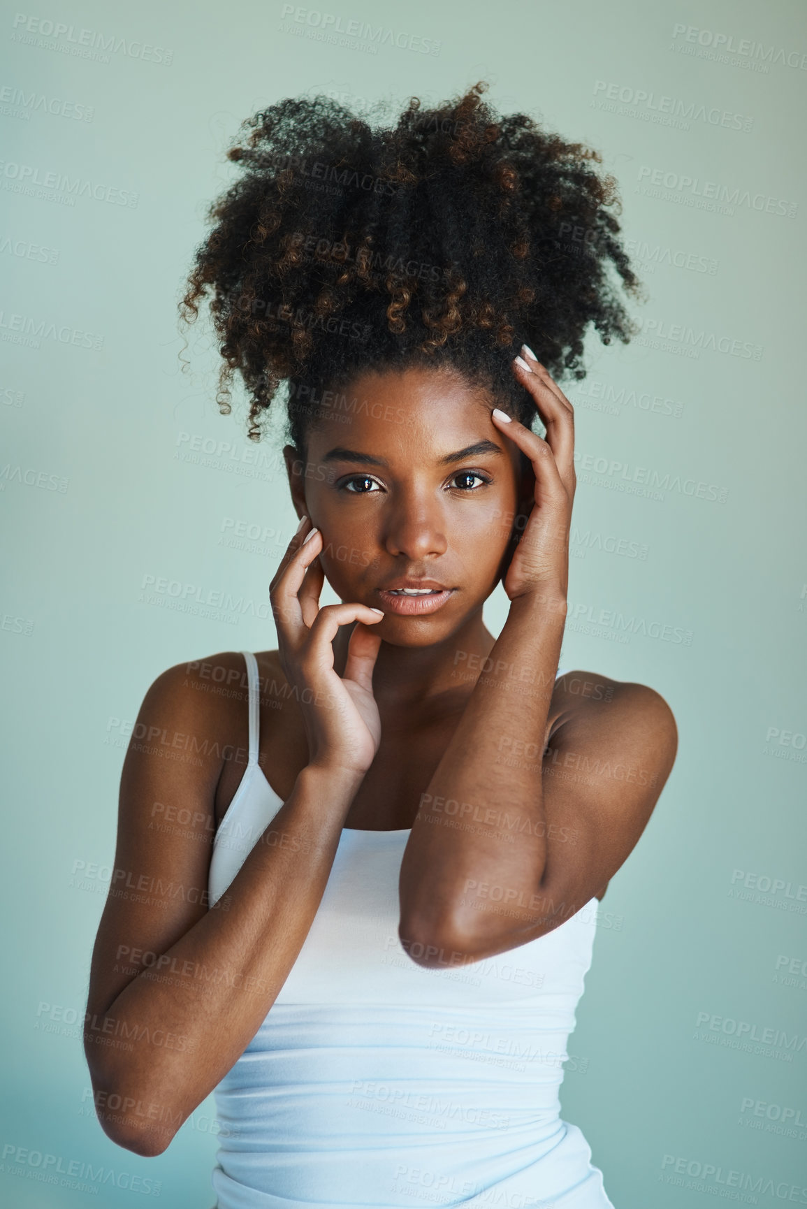 Buy stock photo Studio shot of a beautiful, fresh faced young woman posing against a green background