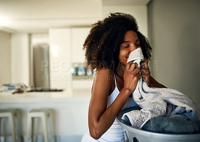 Buy stock photo Laundry smell, African woman and home cleaning chores with happiness and calm. Smile, fresh clothes and happy with housekeeping of a black female person in a house feeling relax in the morning