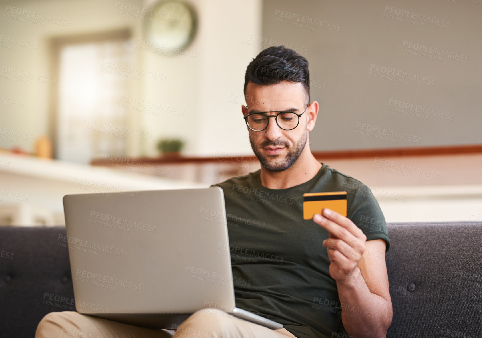 Buy stock photo Laptop, lounge and man with card, home and serious for purchase, subscription and buying of software. House, sofa and payment of credit bills in living room, digital banking and person with glasses