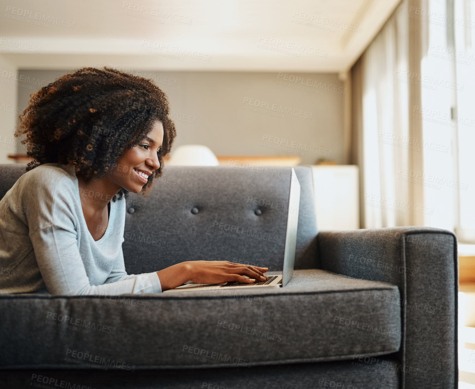 Buy stock photo Shot of an attractive young woman using a laptop at home