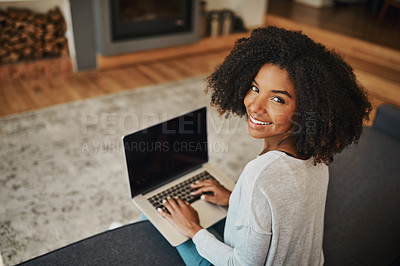 Buy stock photo Portrait of an attractive young woman using a laptop at home