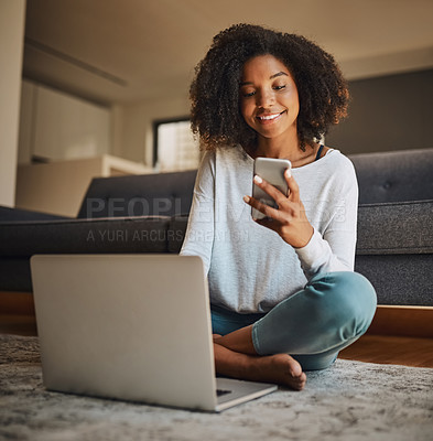 Buy stock photo Shot of an attractive young woman using a cellphone and laptop at home