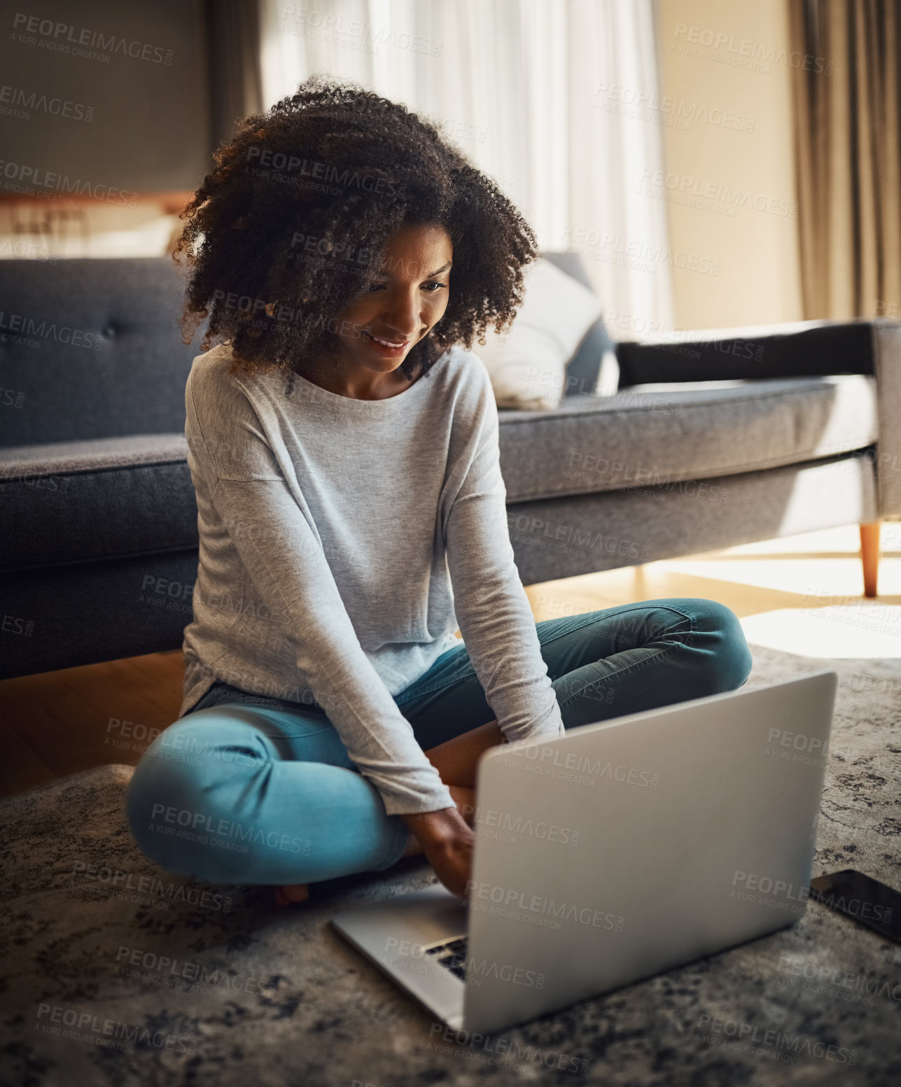 Buy stock photo Shot of an attractive young woman using a laptop at home