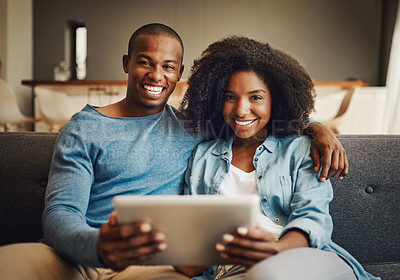 Buy stock photo Portrait of a young couple using a digital tablet together at home