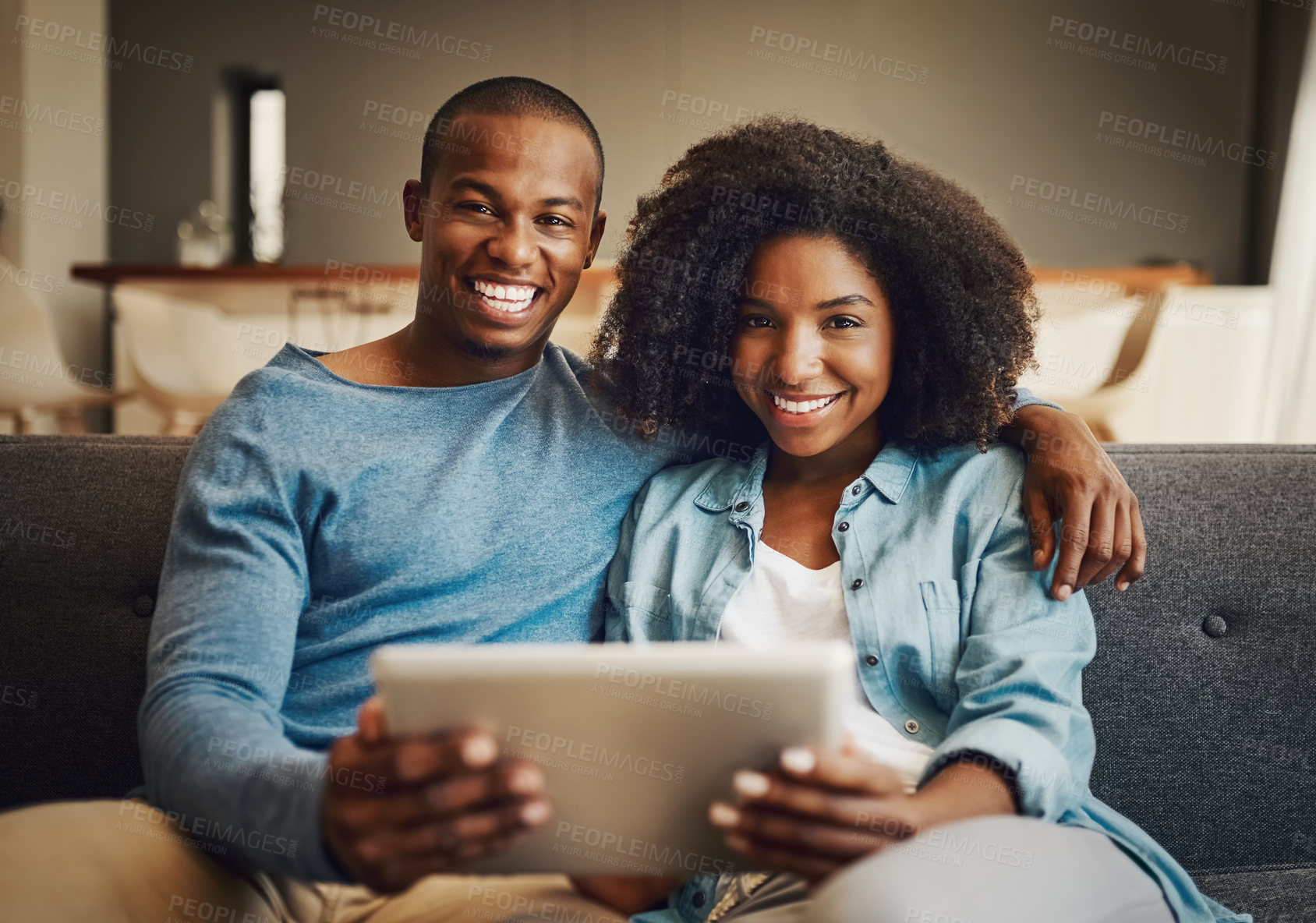 Buy stock photo Portrait of a young couple using a digital tablet together at home