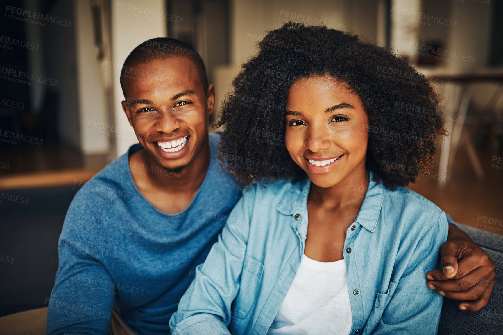 Buy stock photo Portrait of an affectionate young couple relaxing at home