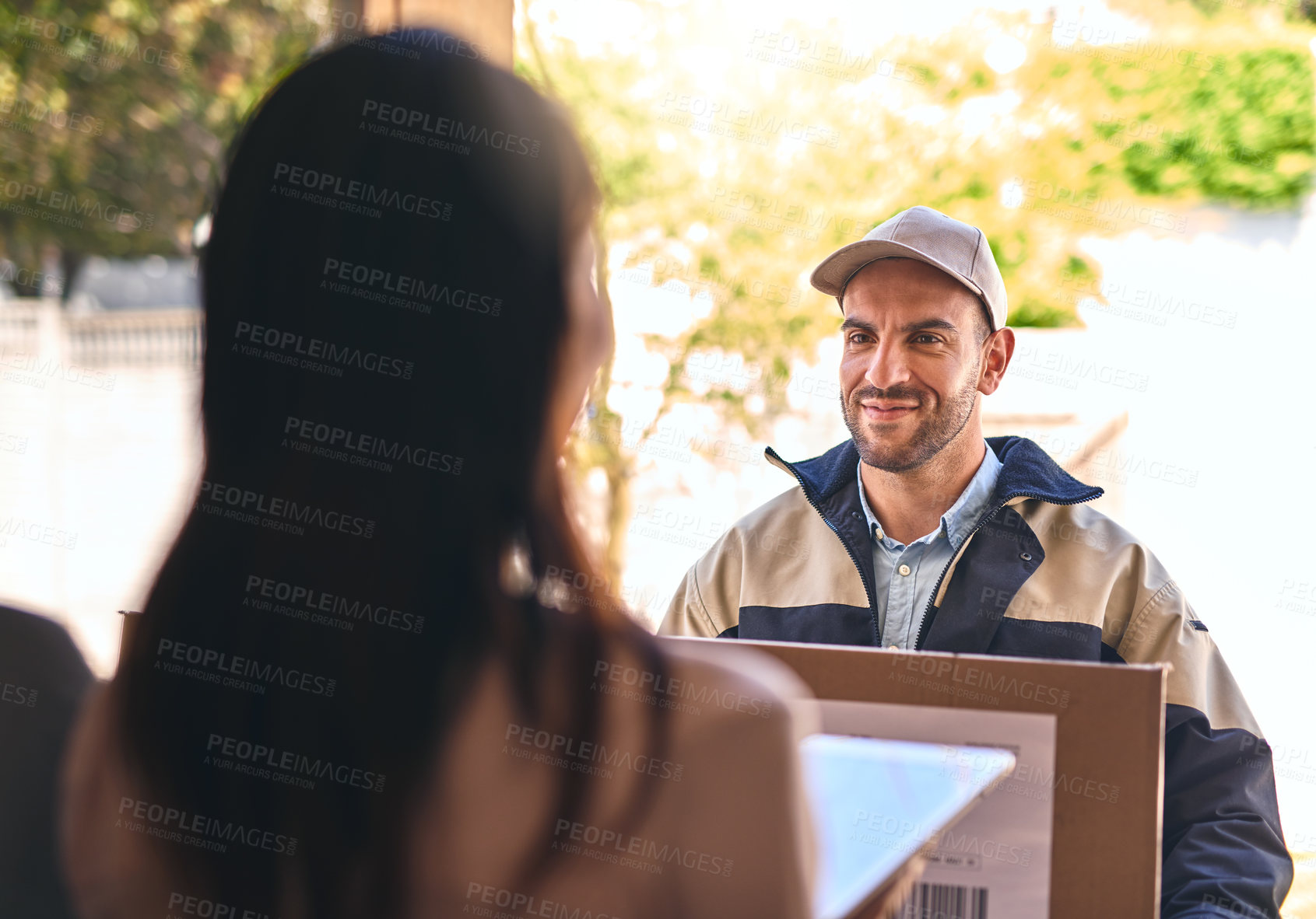 Buy stock photo Shot of a courier making a delivery to a customer 
