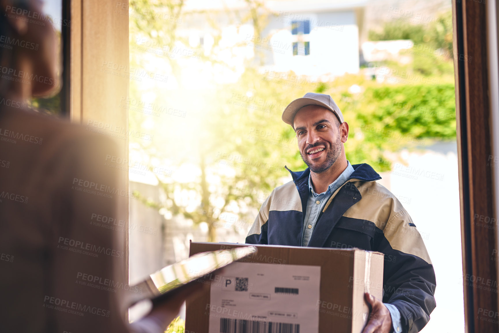 Buy stock photo Shot of a courier making a delivery to a customer 