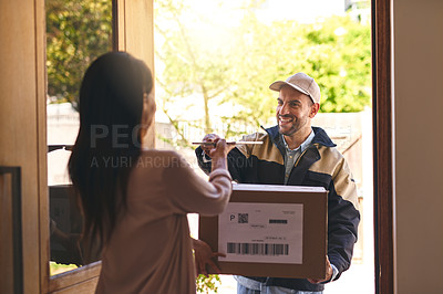 Buy stock photo Shot of a courier handing over a digital tablet to a customer to sign for her delivery