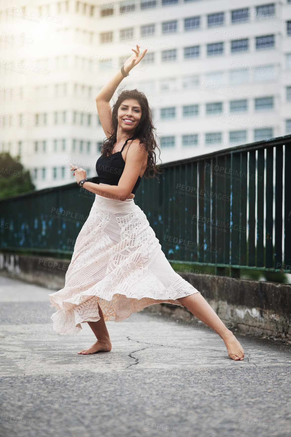 Buy stock photo Portrait of an attractive young woman dancing in the city