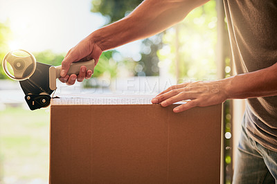 Buy stock photo Closeup shot of an unrecognizable man closing a cardboard box with tape