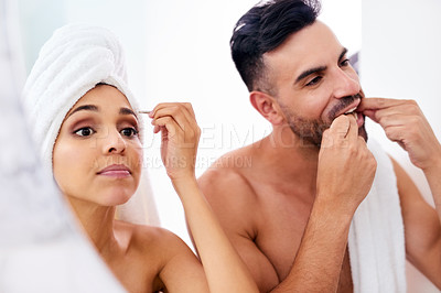 Buy stock photo Shot of a young couple going through their morning routine together at home