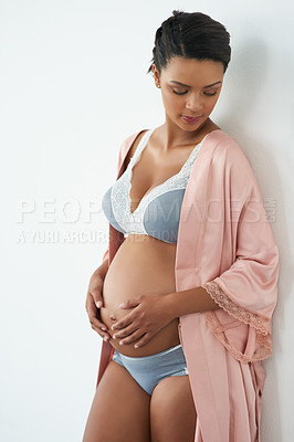 Buy stock photo Pregnancy, happy and woman in studio with stomach for love, care and maternity. Pregnant, underwear and isolated person holding belly for health, wellness and fertility on white wall background