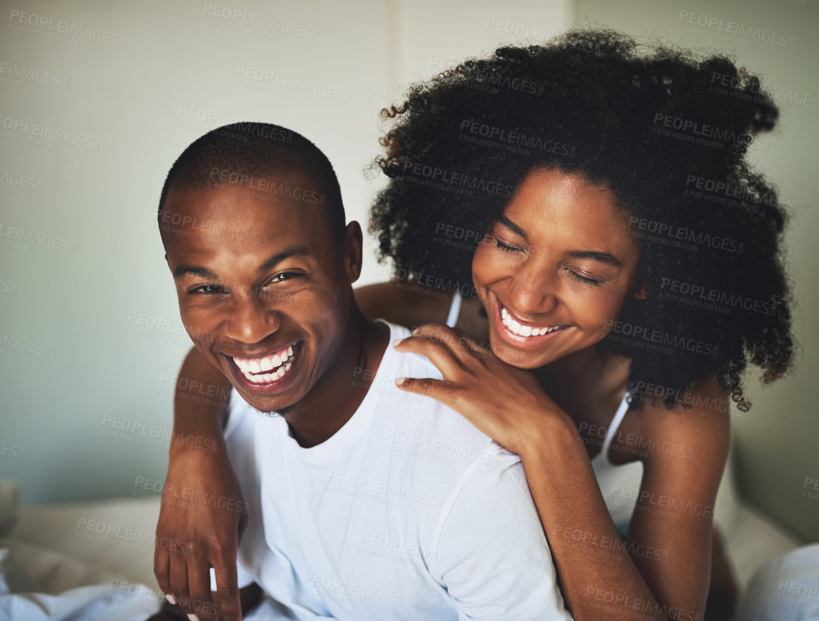 Buy stock photo Portrait of a happy young couple having fun together in bed at home