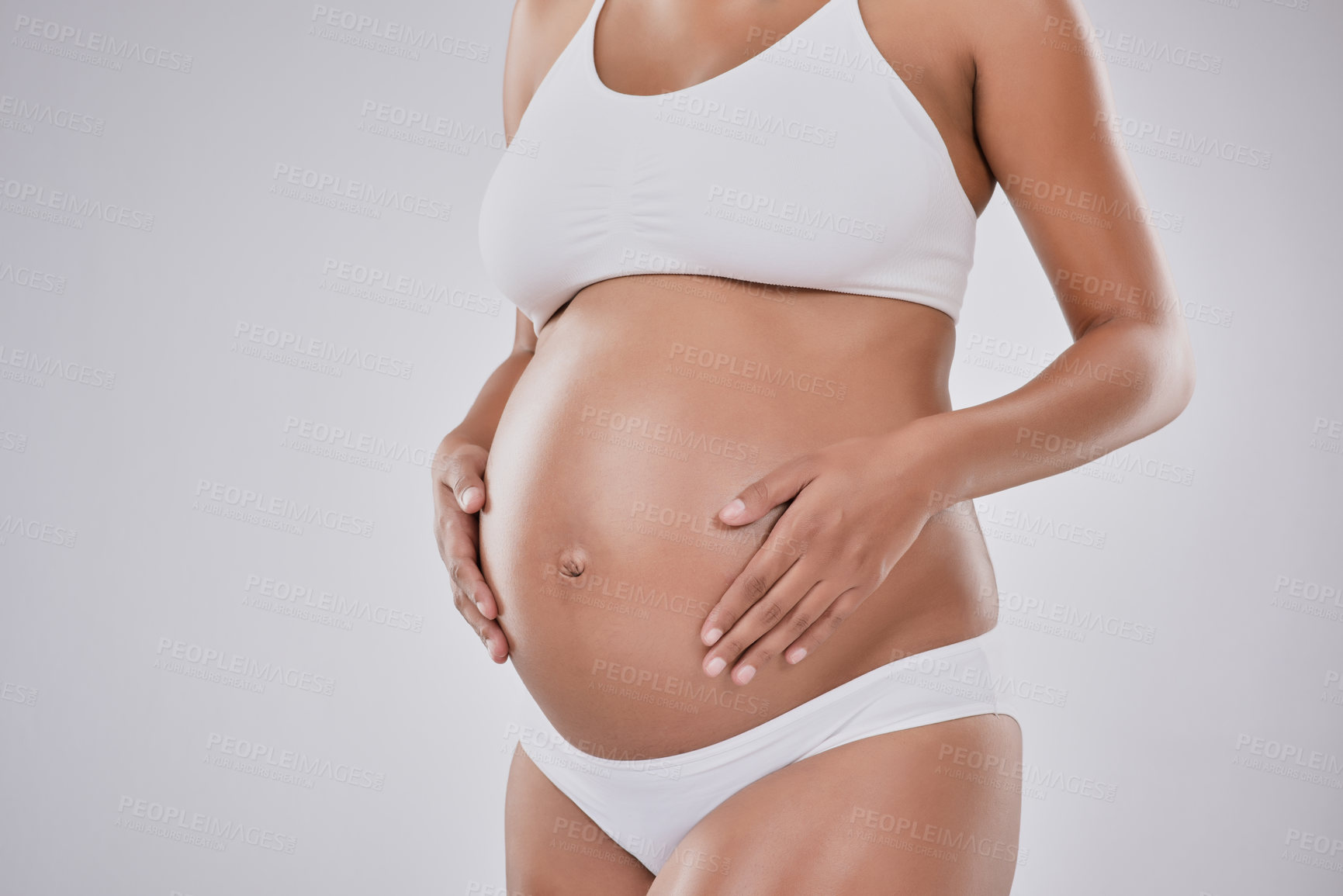 Buy stock photo Pregnancy, stomach and health with woman in studio for belly size, gynecology and maternal. Prenatal, growth and development with body of pregnant person on white background for motherhood mockup