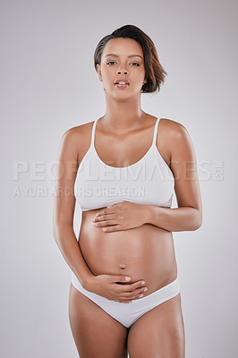 Buy stock photo Woman, face and underwear in studio for pregnant, motherhood and stomach growth with prenatal care. Female person, portrait and lingerie on white background for pregnancy, maternity and gynecology