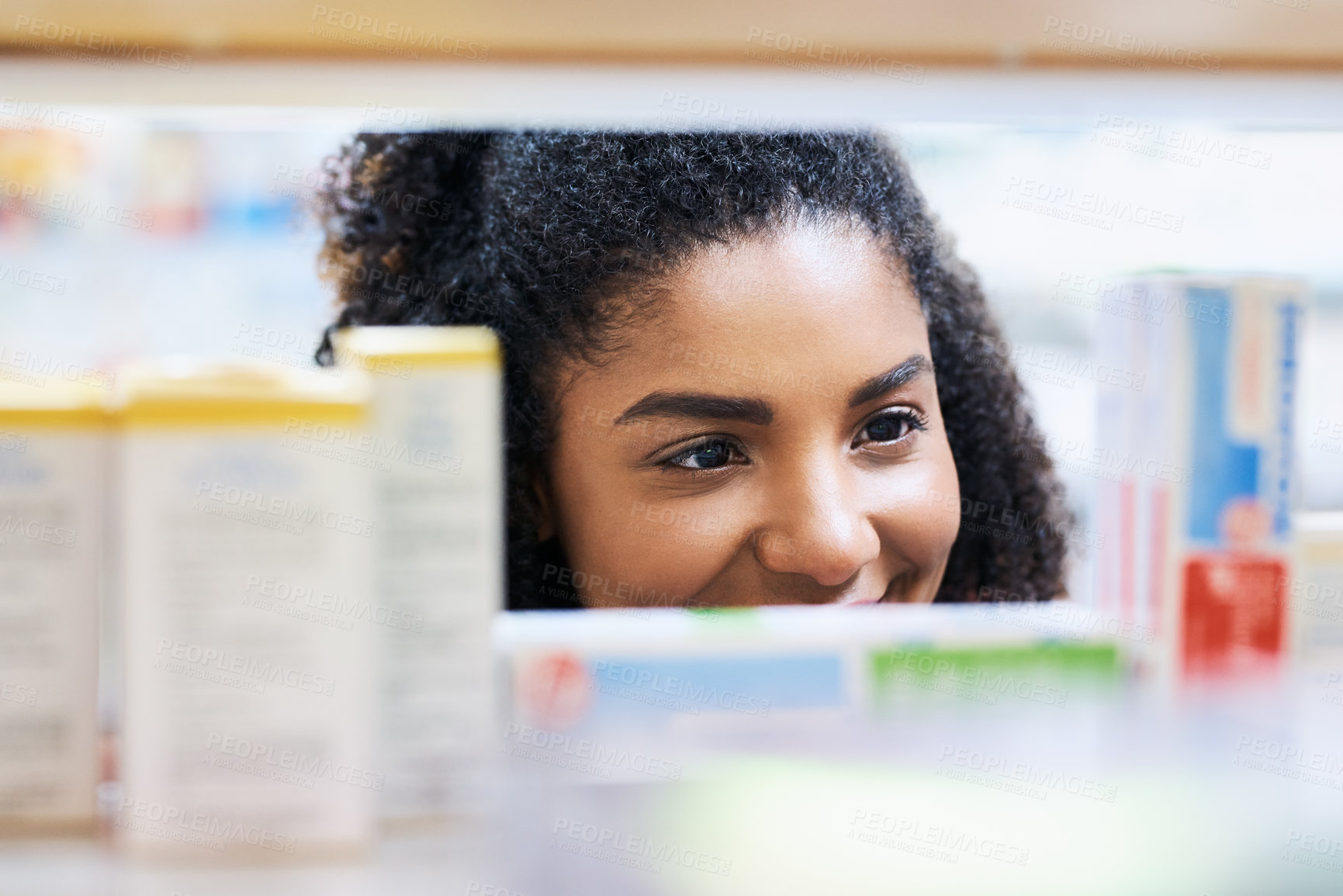 Buy stock photo Pharmacy, healthcare and woman at shelf to check medical info, choice or price of prescription medicine. Smile, thinking and customer reading product label for health benefits of pharmaceutical drugs